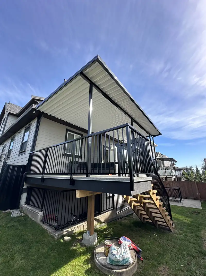 Aluminum patio cover over a deck with picket and stair railing