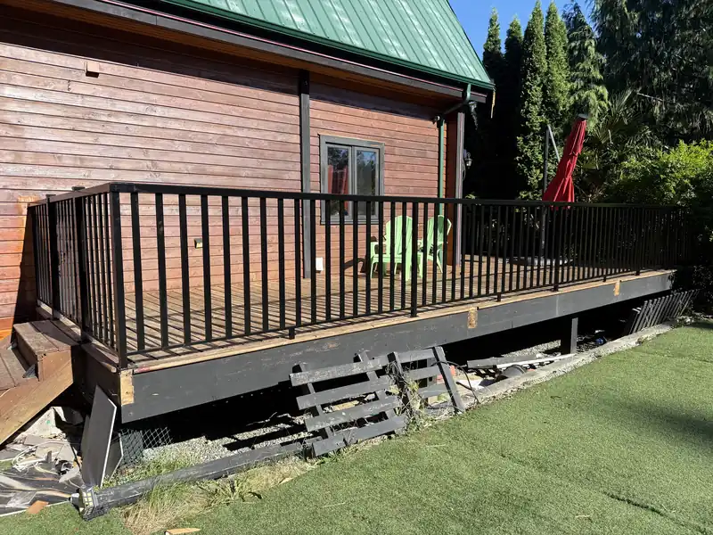 Long run of wide-picket railing on a cedar-sided house deck