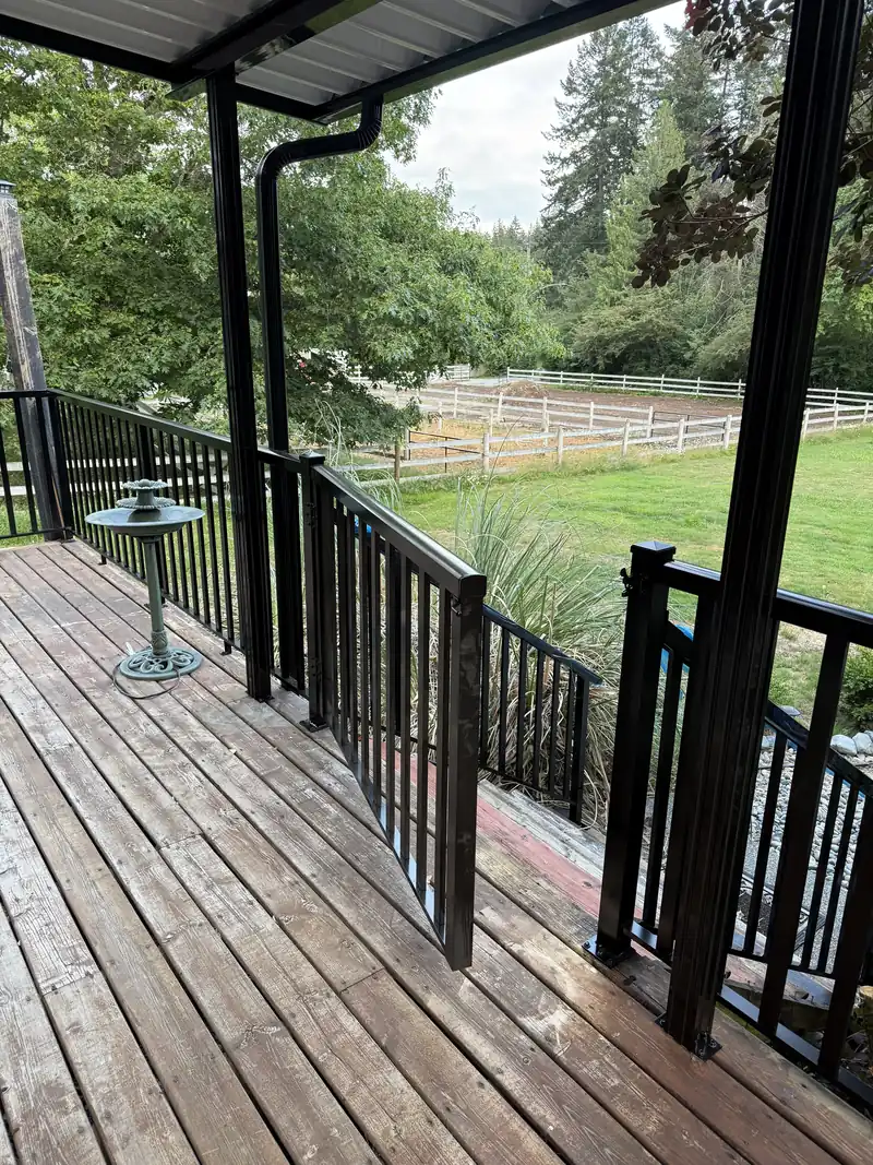 Picket railing and gate on a covered wood deck