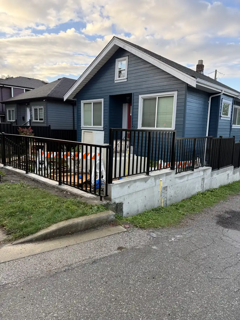 Wide-picket railing on a concrete retaining wall