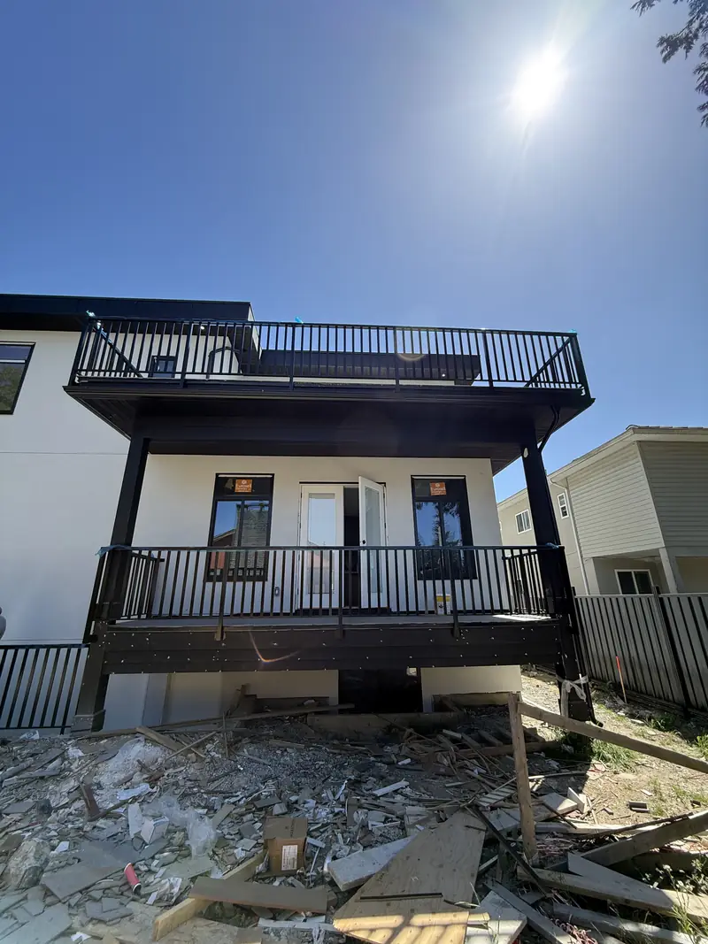 Two levels of wide-picket railing on a house under construction