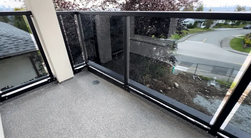 Clear tinted glass railing on a corner balcony