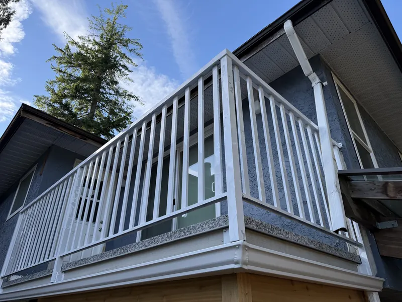White powder-coated wide-picket balcony railing